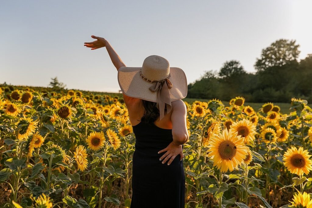 sunflowers, field, beautiful flowers, nature, flowers, meadow, woman, model, hat, dress, flower background, pose, flower wallpaper, joy, freedom